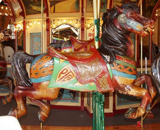 A person standing in front of a carousel
Description generated with high confidence
