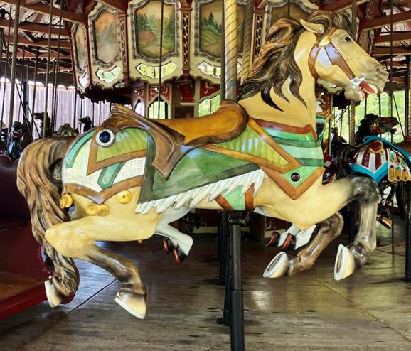 A carousel with horses on it

AI-generated content may be incorrect.