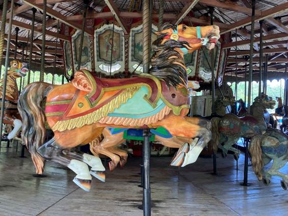 A carousel with horses on a pole

AI-generated content may be incorrect.