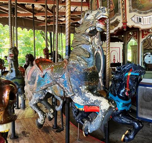 A carousel with horses and a bell

AI-generated content may be incorrect.