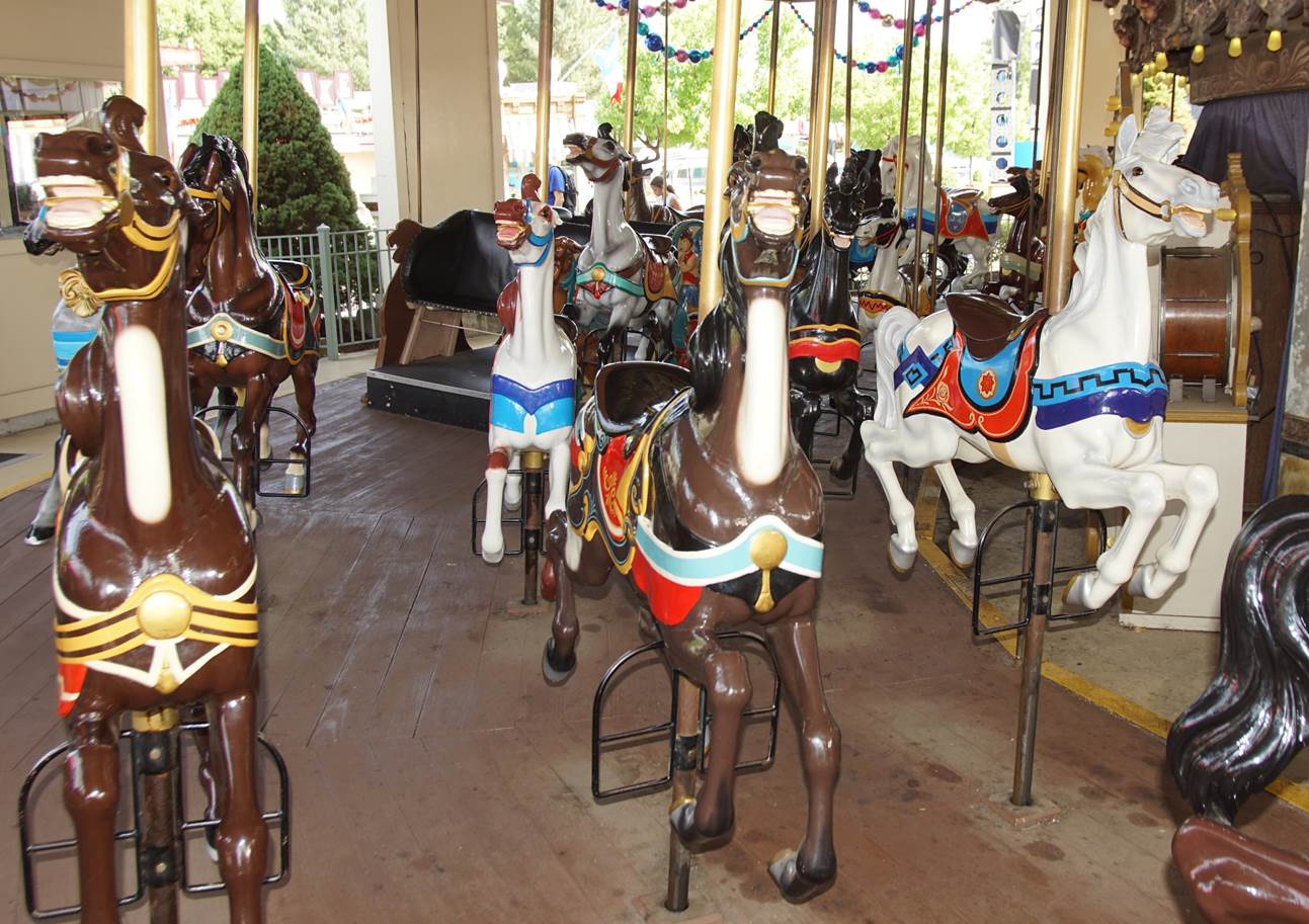 A group of horses on a merry go round

Description automatically generated