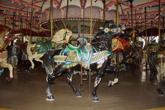 A group of people in a carousel

Description automatically generated