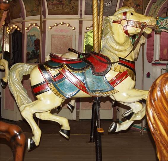 A chair sitting in front of a carousel

Description automatically generated