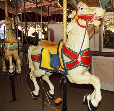 A person standing in front of a carousel

Description automatically generated