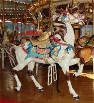 A person standing in front of a carousel

Description automatically generated