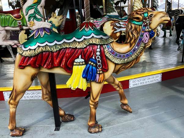 A carousel horse with a camel

AI-generated content may be incorrect.
