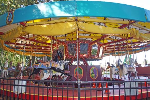 A group of people in a carousel
Description automatically generated