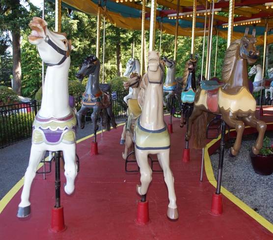 A person standing in front of a carousel
Description automatically generated