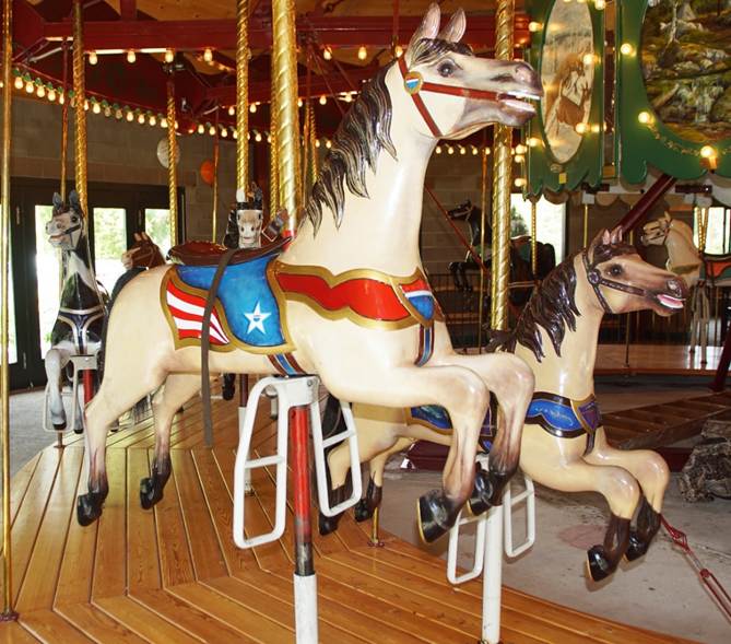 A picture containing carousel, ride, outdoor object, building

Description automatically generated