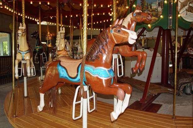 A chair sitting in front of a carousel

Description automatically generated