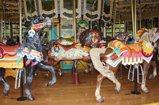 A group of people in a carousel

Description automatically generated