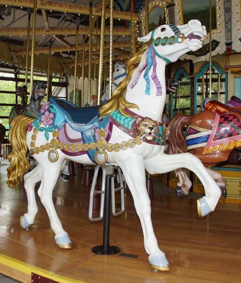A person standing in front of a carousel
Description automatically generated