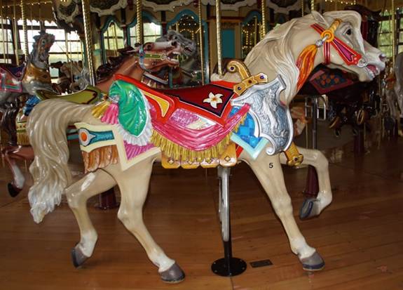 A person standing in front of a carousel
Description automatically generated